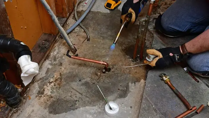 Floor opened to reach copper water lines during a slab leak repair