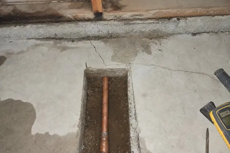 Concrete slab trenched open to expose a leaking copper water line in Vacaville